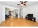 Spacious living room with hardwood floors and an open floor plan to the kitchen and staircase at 746 Wickham Ridge Rd, Apex, NC 27539