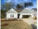 Charming single-story home featuring a two-car garage, landscaping, and inviting curb appeal at 75 Bald Cypress Ln, Youngsville, NC 27596