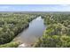 Panoramic aerial view of a lush, green neighborhood featuring a calm, scenic river at 7705 Glenharden Dr, Raleigh, NC 27613