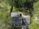 Aerial view of the home showcasing its lush backyard, screened-in porch, deck, outbuilding, and beautiful tree coverage at 7705 Glenharden Dr, Raleigh, NC 27613