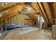 Unfinished attic space with exposed wood framing, insulation, and plywood floor at 7705 Glenharden Dr, Raleigh, NC 27613