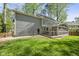 Home's backyard featuring an enclosed screened in porch and wooden deck, perfect for outdoor entertaining at 7705 Glenharden Dr, Raleigh, NC 27613