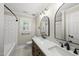 Updated bathroom features a double sink, marble countertops, subway tile and modern fixtures at 7705 Glenharden Dr, Raleigh, NC 27613