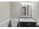Bathroom featuring granite countertop and a toilet with decorative trim at 7705 Glenharden Dr, Raleigh, NC 27613
