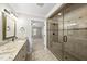 Bathroom boasts a tiled walk-in shower, granite vanity, and access to the Primary at 7705 Glenharden Dr, Raleigh, NC 27613