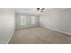 Comfortable bedroom with neutral carpeting and natural light from two windows at 7705 Glenharden Dr, Raleigh, NC 27613