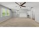 Spacious bonus room with plush carpet, neutral paint, ceiling fan and bright natural light at 7705 Glenharden Dr, Raleigh, NC 27613