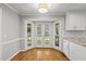 Cozy breakfast nook with hardwood floors, white trim, and doors to the backyard at 7705 Glenharden Dr, Raleigh, NC 27613