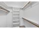 Walk-in closet with built-in shelving and wooden rods, offers practical storage solutions at 7705 Glenharden Dr, Raleigh, NC 27613
