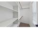 Walk-in closet with shelving and wooden rods, offering ample storage space at 7705 Glenharden Dr, Raleigh, NC 27613