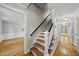 Traditional foyer featuring hardwood floors, staircase with white railings, and elegant trim at 7705 Glenharden Dr, Raleigh, NC 27613