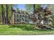 Traditional two-story home featuring gray siding, black shutters, and a well-manicured front lawn at 7705 Glenharden Dr, Raleigh, NC 27613