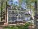 Charming gray home with a two-car garage, white trim, dormer windows, and a manicured lawn at 7705 Glenharden Dr, Raleigh, NC 27613