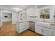 Bright kitchen featuring white cabinets, stainless steel appliances, and granite countertops at 7705 Glenharden Dr, Raleigh, NC 27613
