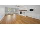 Bright living room with hardwood floors, fireplace, and modern ceiling fan at 7705 Glenharden Dr, Raleigh, NC 27613