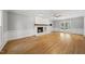 Spacious living room with fireplace, and access to the outdoors through glass doors at 7705 Glenharden Dr, Raleigh, NC 27613