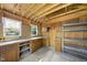 Interior of the storage shed with built-in cabinets, a countertop, pegboard, and shelving unit, ideal for workshop or storage at 7705 Glenharden Dr, Raleigh, NC 27613