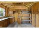 Interior of the storage shed with built-in cabinets, a countertop, pegboard, and shelving unit, ideal for workshop or storage at 7705 Glenharden Dr, Raleigh, NC 27613