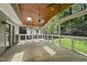 Inviting screened-in porch with wood ceiling, skylights, ceiling fan, curtains and great view of backyard at 7705 Glenharden Dr, Raleigh, NC 27613