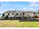 View of house backyard featuring patio, wooden deck, grass, and privacy fence at 807 Clean View Ct, Fuquay Varina, NC 27526
