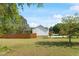 Spacious backyard featuring mature trees and a wooden fence around the property at 807 Clean View Ct, Fuquay Varina, NC 27526