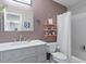 Well-lit bathroom features a gray vanity, a framed mirror, and a shower/tub combo at 807 Clean View Ct, Fuquay Varina, NC 27526