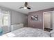 Comfortable bedroom features a ceiling fan, window, and neutral carpet at 807 Clean View Ct, Fuquay Varina, NC 27526