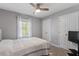 Cozy bedroom features a ceiling fan, neutral paint, and window with natural light at 807 Clean View Ct, Fuquay Varina, NC 27526