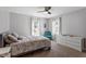 Bright bedroom features two windows, gray walls, and neutral carpet at 807 Clean View Ct, Fuquay Varina, NC 27526