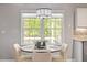 Cozy dining nook with a modern chandelier and a view of the outdoors, perfect for intimate meals at 807 Clean View Ct, Fuquay Varina, NC 27526