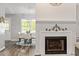 Elegant dining area adjacent to the fireplace, featuring a chandelier and plenty of natural light at 807 Clean View Ct, Fuquay Varina, NC 27526