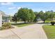 Long driveway with ample parking space, mature trees, and well-maintained landscaping at 807 Clean View Ct, Fuquay Varina, NC 27526