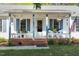 Close-up of the front porch with seating, plants, and an American flag, enhancing curb appeal at 807 Clean View Ct, Fuquay Varina, NC 27526
