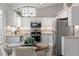 Updated kitchen with stainless steel appliances, white cabinets, and stylish lighting, perfect for cooking and dining at 807 Clean View Ct, Fuquay Varina, NC 27526