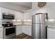 Well-equipped kitchen featuring stainless steel appliances, ample cabinet space, and sleek granite countertops at 807 Clean View Ct, Fuquay Varina, NC 27526