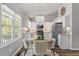 Bright eat-in kitchen with modern appliances, white cabinets and countertops, and a decorative light fixture at 807 Clean View Ct, Fuquay Varina, NC 27526
