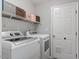 Efficient laundry room includes modern washer and dryer units plus plenty of overhead storage at 807 Clean View Ct, Fuquay Varina, NC 27526