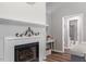 Comfortable living room featuring a cozy fireplace and access to an adjoining bathroom at 807 Clean View Ct, Fuquay Varina, NC 27526