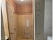 Enclosed shower stall with a door in a bathroom with vintage wallpaper at 811 New Kent Pl # 1A, Cary, NC 27511