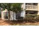 View of condominium exterior with windows, a balcony, and mature tree in the yard at 811 New Kent Pl # 1A, Cary, NC 27511