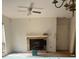 Cozy living room featuring a brick fireplace, ceiling fan, and natural light from the window at 811 New Kent Pl # 1A, Cary, NC 27511