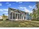 Exterior home view showing an enclosed porch and spacious yard area, with a house design to connect to nature at 858 Lake Artesia Ln, Fuquay Varina, NC 27526