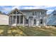 Back exterior of the house featuring a nice enclosed porch area with a home design that connects to nature at 858 Lake Artesia Ln, Fuquay Varina, NC 27526
