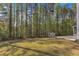 Spacious backyard featuring a storage shed and ample green space, perfect for outdoor activities or enjoying nature at 858 Lake Artesia Ln, Fuquay Varina, NC 27526