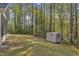 Backyard showing ample green space and a storage shed, blending convenience with the beauty of nature at 858 Lake Artesia Ln, Fuquay Varina, NC 27526
