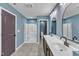 The bathroom features double sinks, a shower, and blue walls, providing a clean and functional space at 858 Lake Artesia Ln, Fuquay Varina, NC 27526