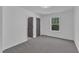 Bedroom with neutral carpet and a window, and two dark doors at 858 Lake Artesia Ln, Fuquay Varina, NC 27526