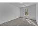 A bedroom has neutral carpet and one window at 858 Lake Artesia Ln, Fuquay Varina, NC 27526