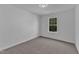 Cozy bedroom with neutral carpet and a window with a wooded view at 858 Lake Artesia Ln, Fuquay Varina, NC 27526
