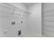 Spacious closet with shelving and hookups for washer and dryer; ready for customization at 858 Lake Artesia Ln, Fuquay Varina, NC 27526